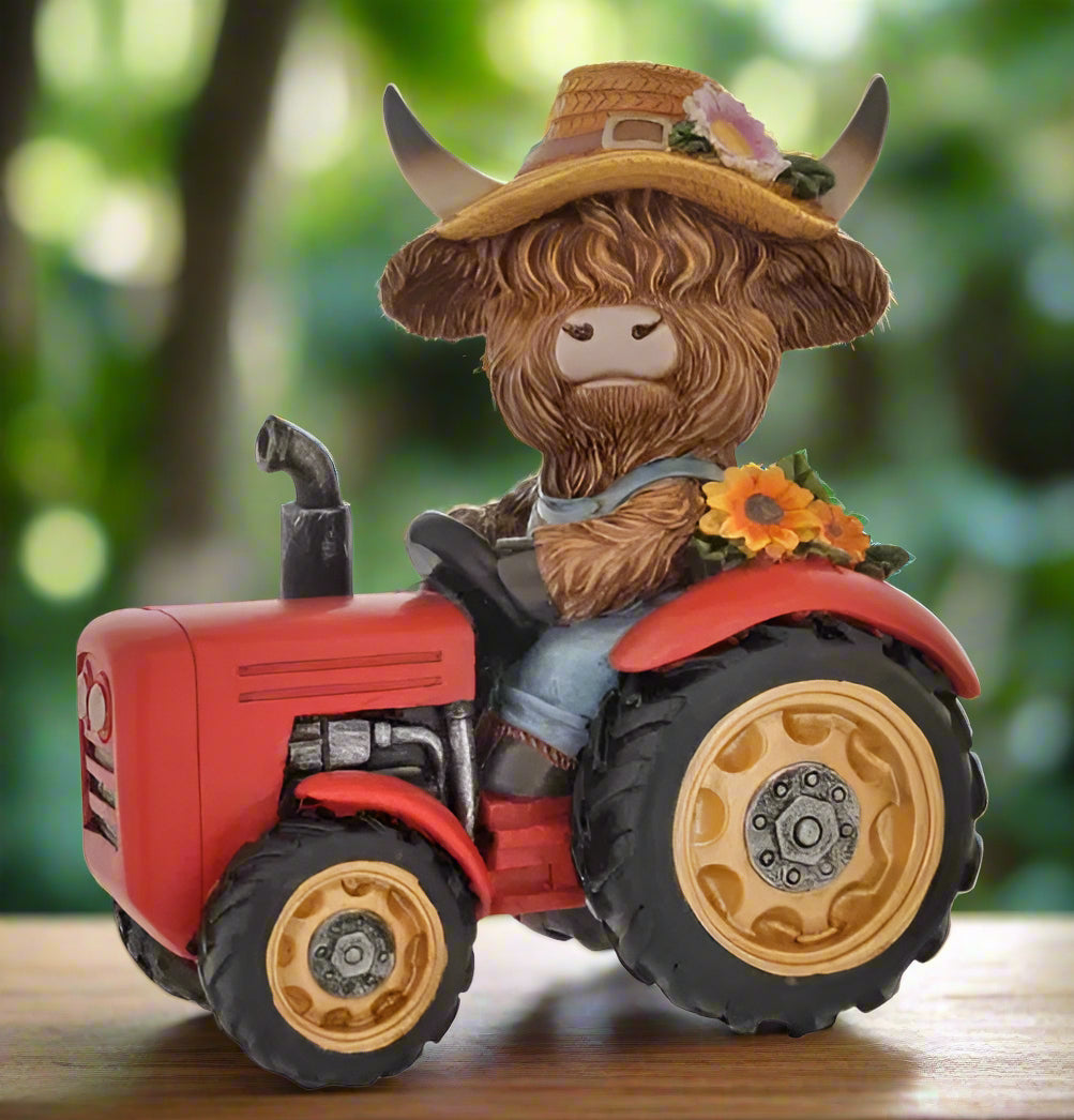 Statue of a cow with a cowboy hat riding a red tractor on a white background
