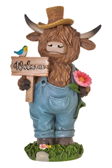 Garden figurine of a cow with a 'Welcome' sign, overalls, and a hat on a white background